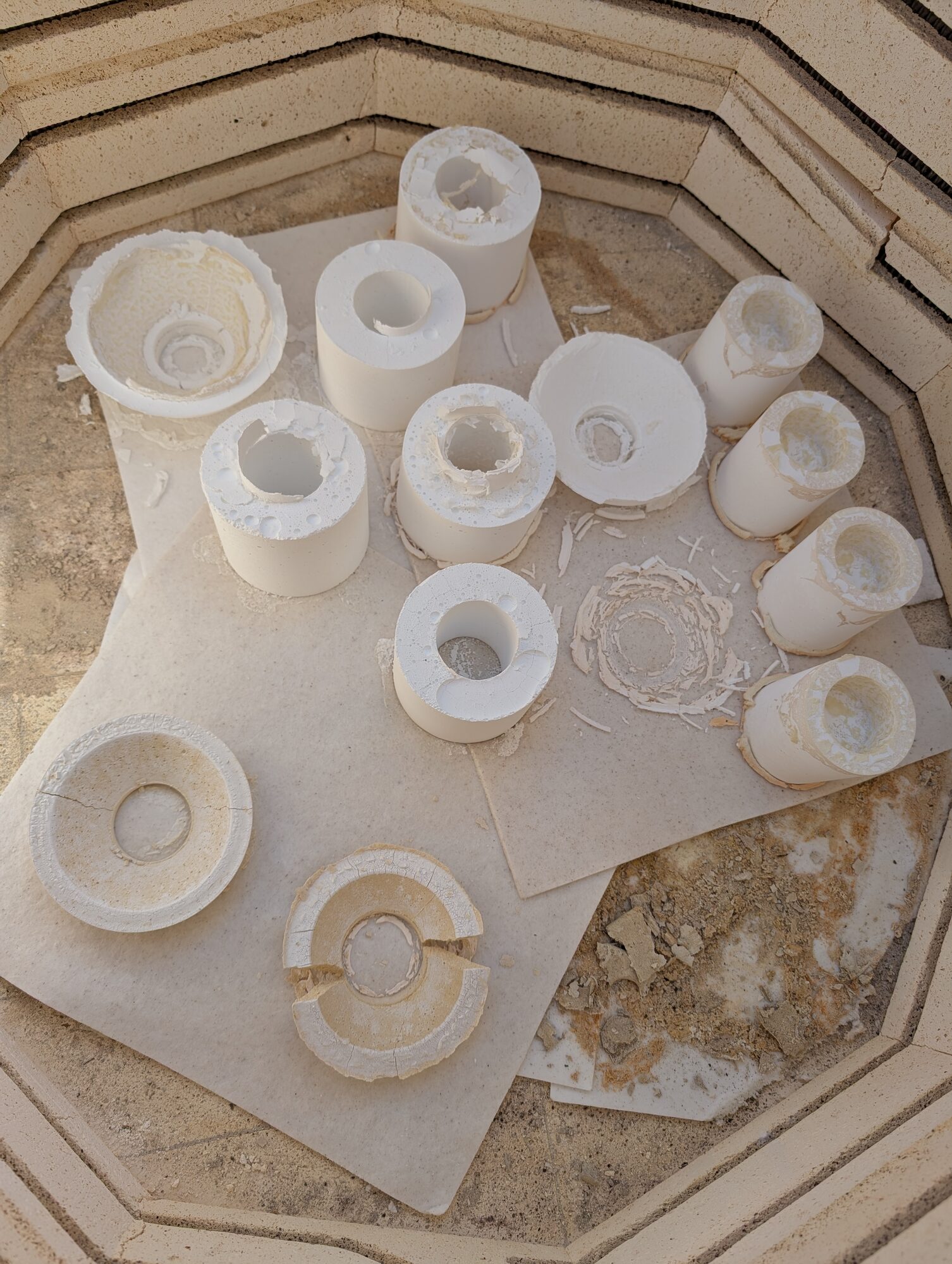 Cast parts and mold remains in the kiln after firing