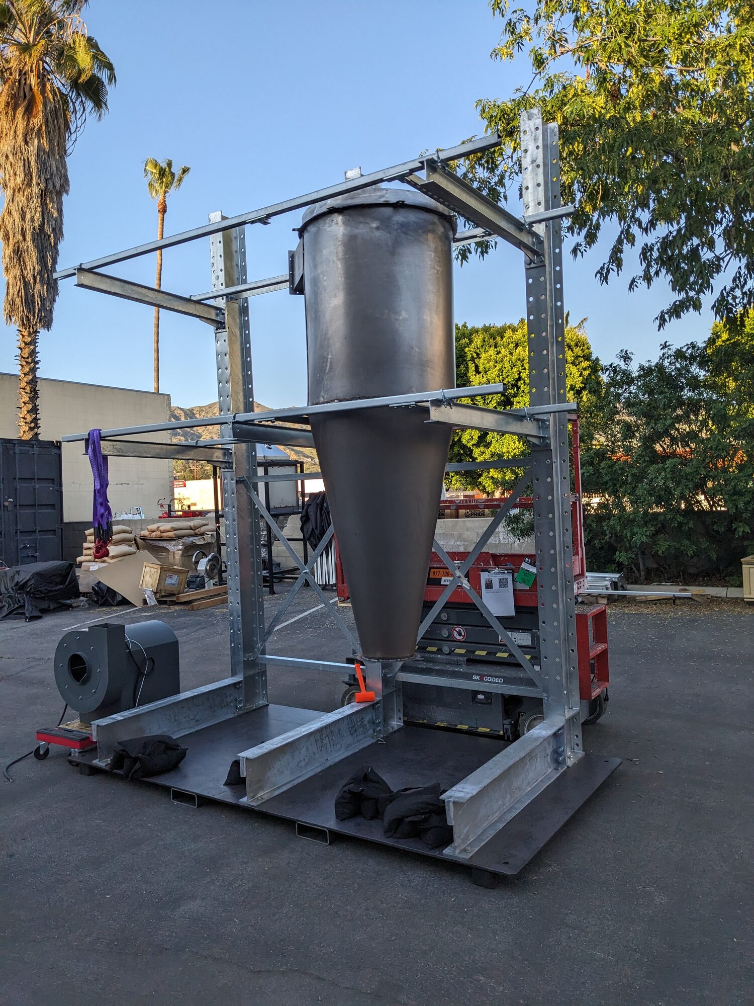 The scaled cyclone assembled in its rack frame, blower at the base