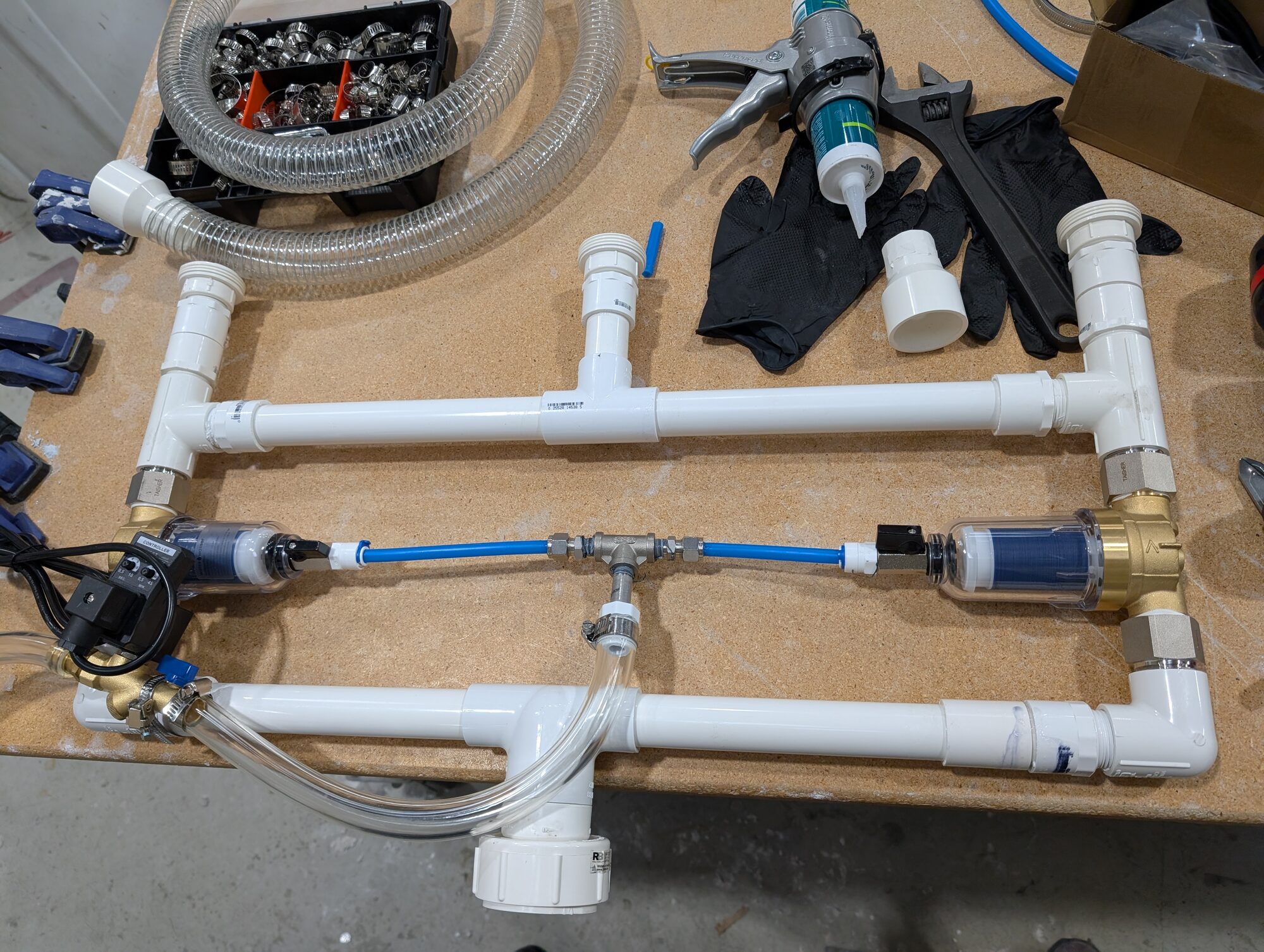 The completed manifold laid out flat on the bench with solenoid, blue sense line and both filters plumbed