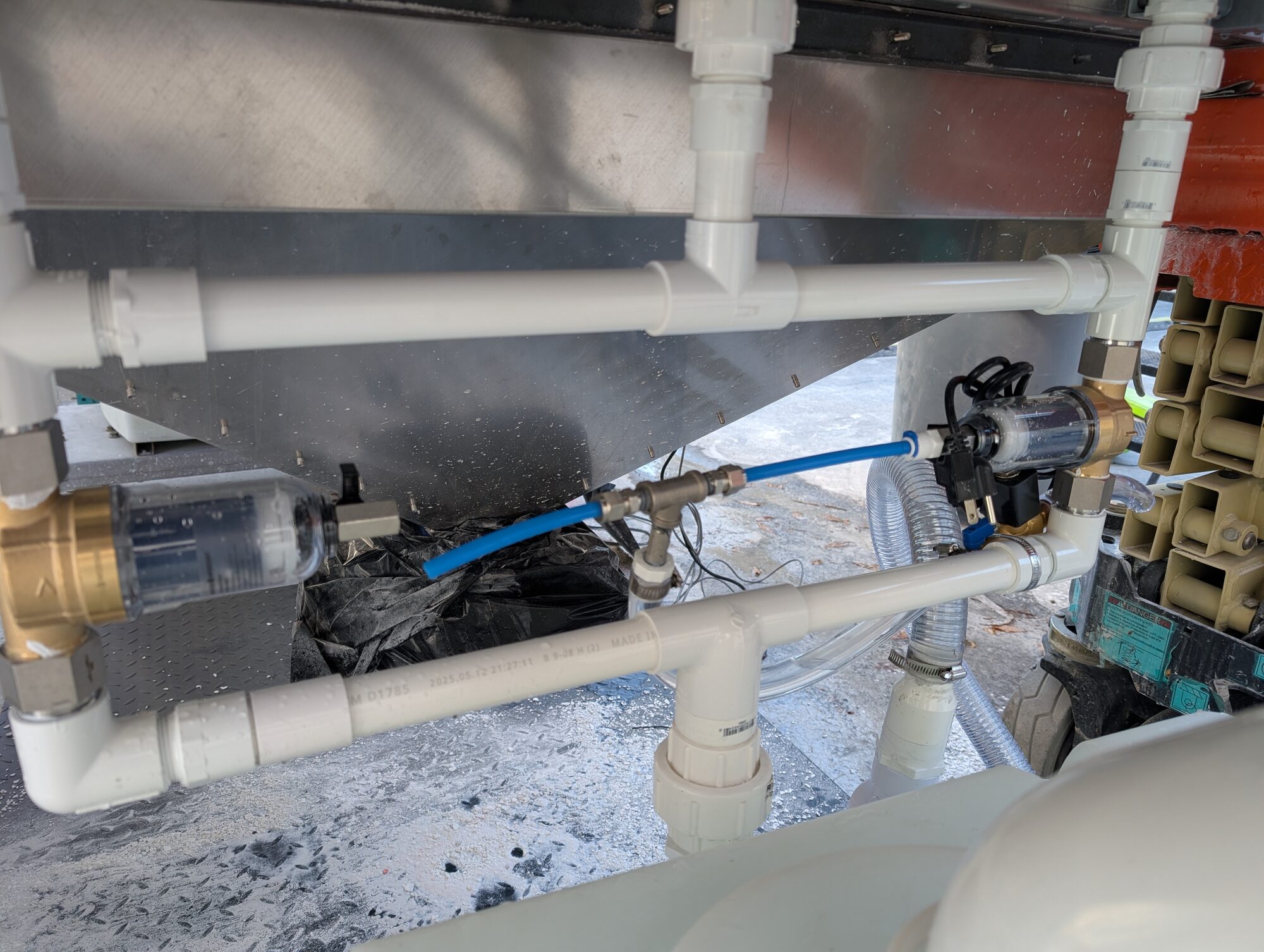 The manifold installed in the shadow under the stainless hopper of the skid