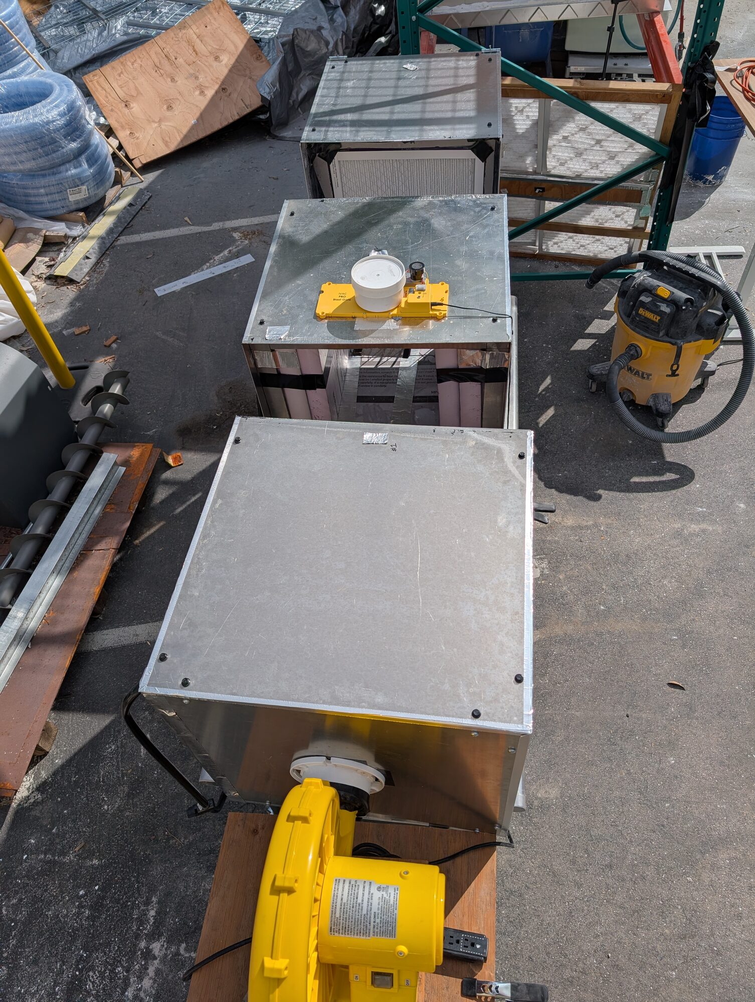 Looking down on the skid from above, the fan at the near end and three cubes in a line beyond it